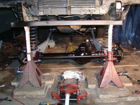 1991 Ford Bronco - Front axle and suspension work being done on a vehicle supported by jack stands.