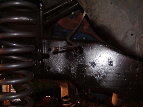 1991 Ford Bronco - Close-up of the undercarriage of a 1991 Ford Bronco, highlighting the frame and suspension.