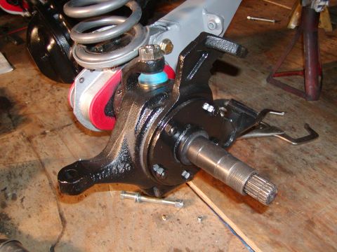 1991 Ford Bronco - Front wheel hub assembly with suspension components and a coil spring. Part number visible.
