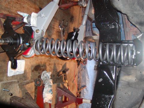 1991 Ford Bronco - Vehicle suspension components are shown in a workshop setting, with tools and stands visible.