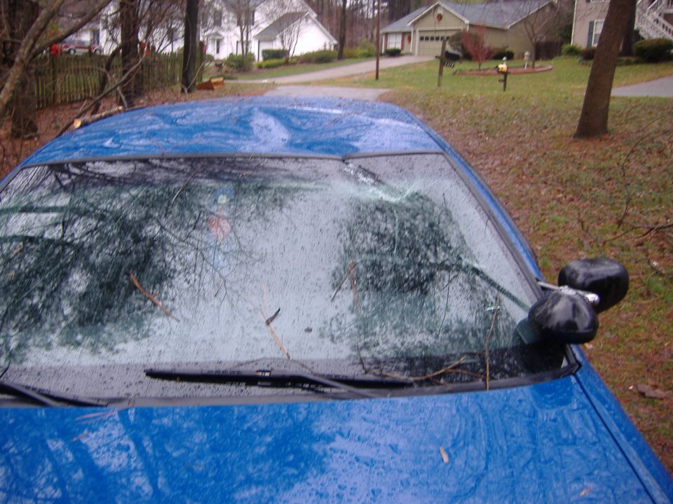 Blue 1998 Ford Crown Victoria with cracked windshield and two side mirrors visible