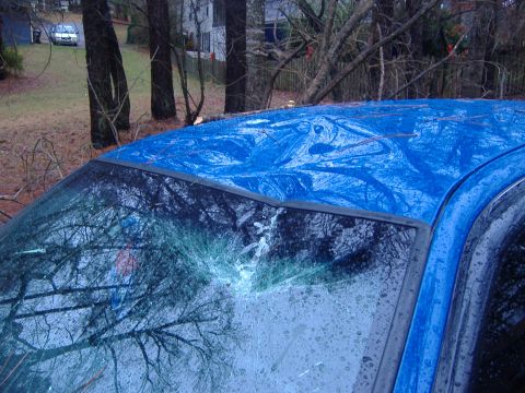 1998 Ford Crown Victoria - The blue car's roof appears to be covered by a tarp, and the windshield is shattered.