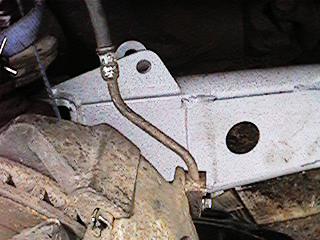 1986 Ford Bronco - Detail of a vehicle's undercarriage, focusing on the brake system components.