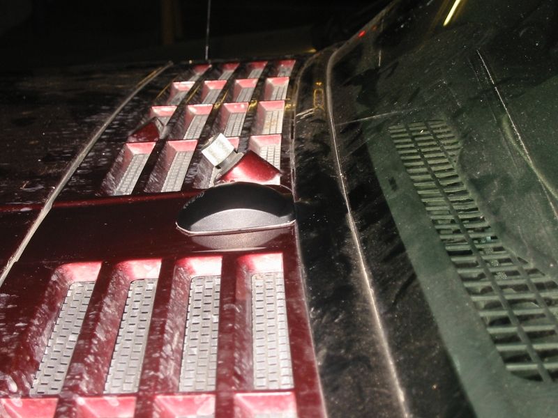 Antenna in place against the windshield seal; the backing from the adhesive has been removed and it's now permanently mounted.  Note that the wiring to the antenna itself is not exposed.