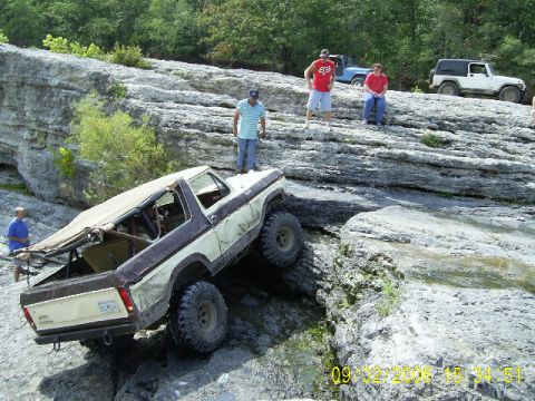 1979 Ford Bronco - Off-road enthusiasts tackle a challenging rocky trail with their modified Ford Bronco and other vehicles.