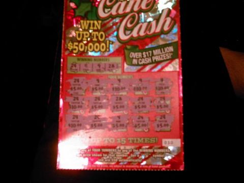 1986 Ford Bronco - A Cane Cash scratch-off ticket is shown, advertising a chance to win up to $50,000.