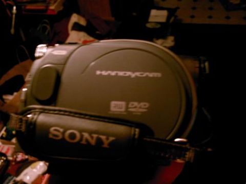 1986 Ford Bronco - A Sony Handycam camcorder with DVD RW is visible, along with its black Sony strap.