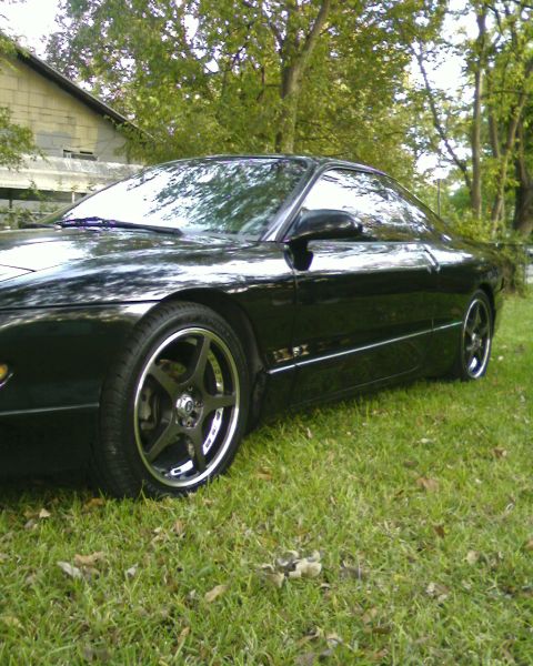 1996 Ford Probe - A black 1996 Ford Probe is shown from the front three-quarter view, parked on a grassy area.