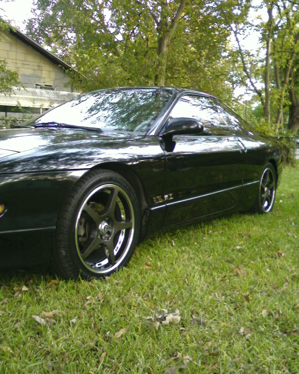 Black 1996 Ford Probe parked on grass, side view