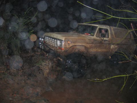 1992 Ford Mustang - This 1978 Ford Bronco is navigating a muddy trail at night, its headlights cutting through the darkness.