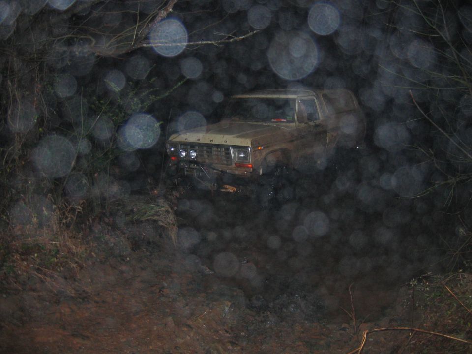 Ford Bronco driving off-road at night