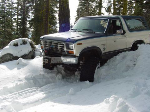 1986 Ford Bronco - This 1986 Ford Bronco navigates a snowy trail, its off-road capabilities.