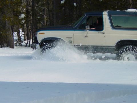 1986 Ford Bronco - This 1986 Ford Bronco kicks up snow as it drives through a winter landscape.