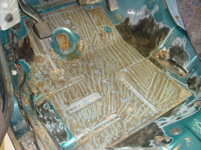 Vehicle interior floor with rust damage and repair work