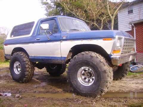 1978 Ford Bronco - This lifted 1978 Ford Bronco features prominent off-road tires and a two-tone blue and white paint scheme.