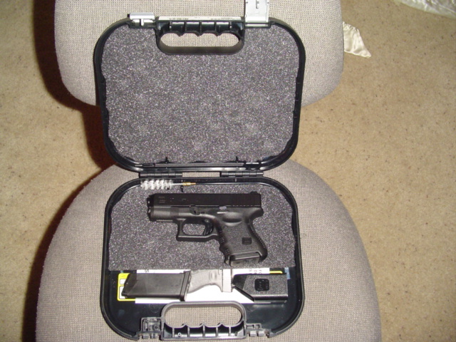 Black pistol in a black case with foam cutouts for the gun and magazines
