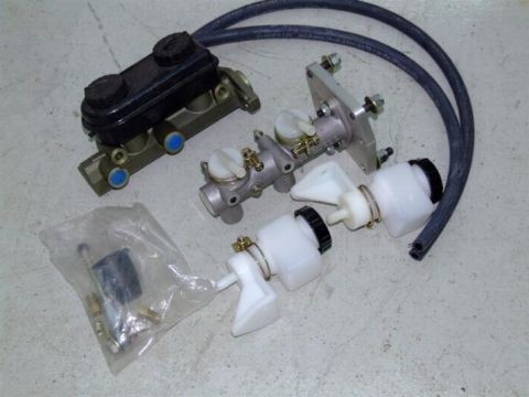 1990 Ford Mustang - Several brake system components, including master cylinders and reservoirs, are arranged on a textured floor.