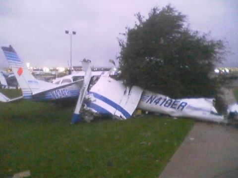 1989 Ford Bronco - Two airplanes are damaged and resting on the grass, with one having registration N410ER and the other N434FE visible.