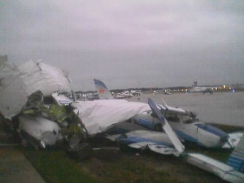 1989 Ford Bronco - A small airplane has crashed on the tarmac, with debris scattered around it.