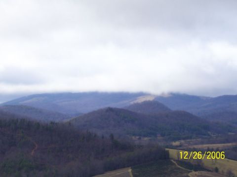 1993 Ford Bronco - Overcast sky hangs over a vast mountain landscape, with a date and website visible.