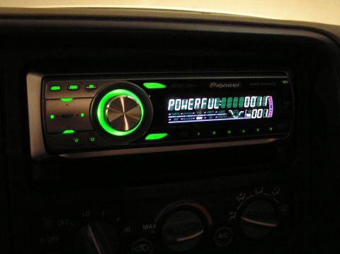 2000 Chevrolet Tahoe - Close-up of a Pioneer car stereo with illuminated green accents and a digital display.