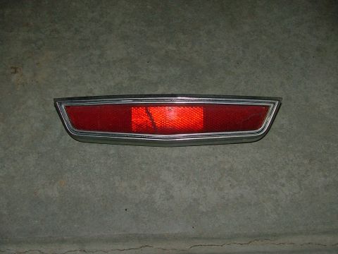 1969 Ford Ranchero - A single vehicle tail light assembly with a chrome bezel is shown against a textured surface.