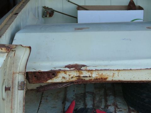 1969 Ford Ranchero - Close-up view of significant rust and deterioration on the edge of a vehicle's tailgate.