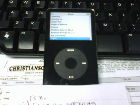1984 Ford Bronco - An iPod Classic is placed on a keyboard and some documents.