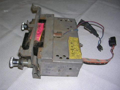 1975 Ford Ranchero - Car radio part with visible wiring and labels for AM/FM functions.