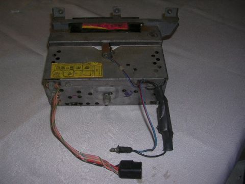1975 Ford Ranchero - This is a close-up view of the back of an old car radio, showing its wiring and a warning label.