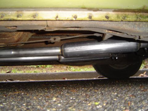 1973 Ford Torino - Close-up view of a dual exhaust system, showing the mufflers and pipes beneath the car's chassis.