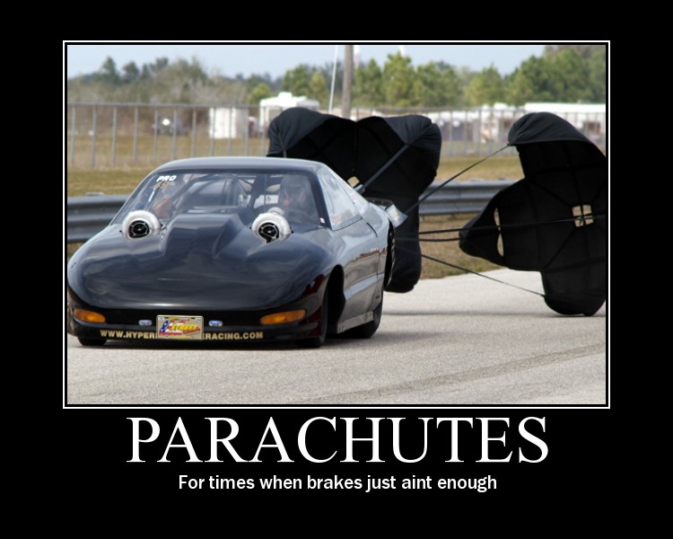 Black drag car with twin parachutes deployed, front view