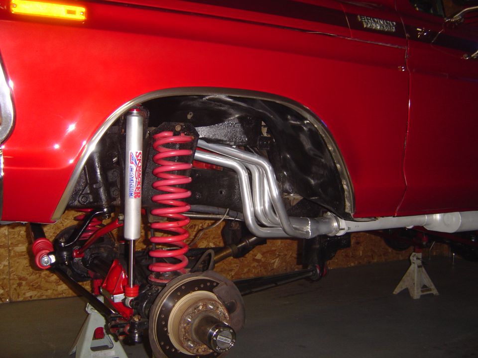 Red 1978 Ford Bronco side view showing custom suspension and exhaust system