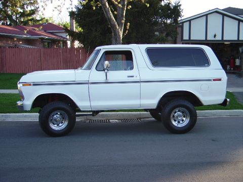 1978 Ford Bronco - Side profile of a white 1978 Ford Bronco parked on a suburban street.