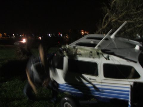 1989 Ford Bronco - Small airplane on trailer at night, possibly damaged by tornado.