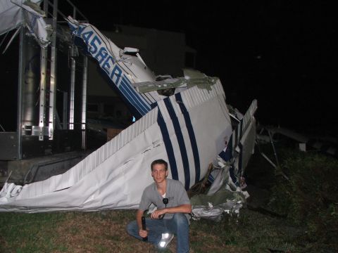 1989 Ford Bronco - Wrecked airplane fuselage with visible registration number 458ER and a person observing the scene.