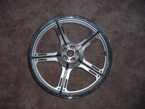 2002 Harley-Davidson Sportster Custom - A motorcycle wheel is shown against a brown carpet background.