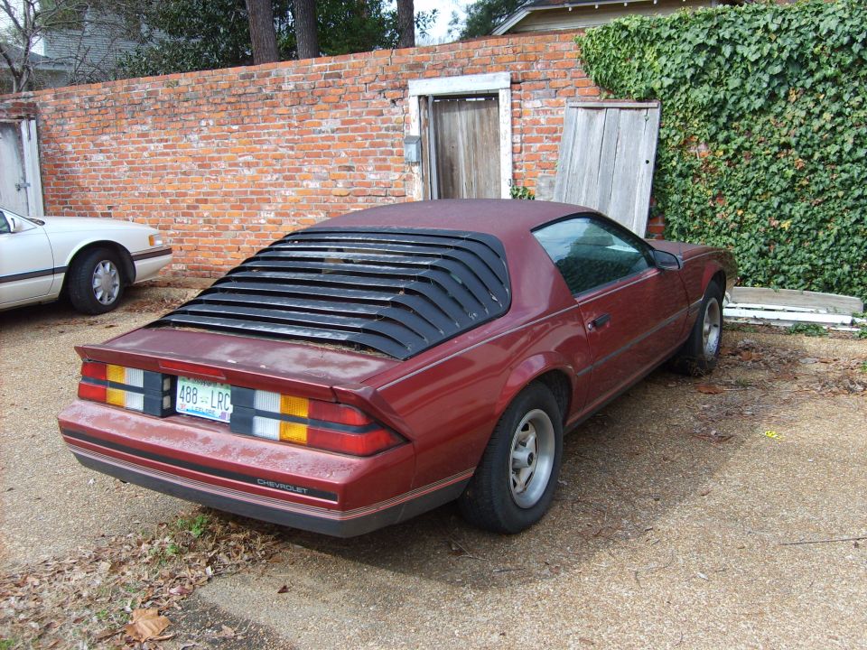 Red coupe with rear louvers and a "488 LRC" license plate