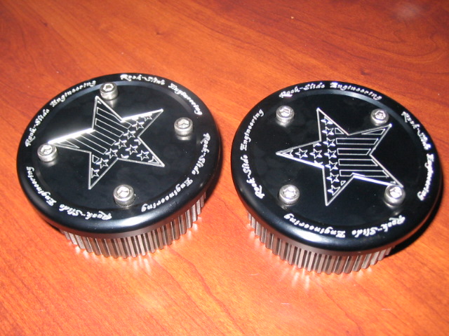 Two black circular parts with a star design and 'Rock-Slide Engineering' text