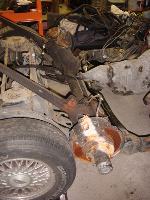 1991 Ford Bronco - This image shows a disassembled vehicle's frame, suspension, and drivetrain components, appearing heavily rusted.