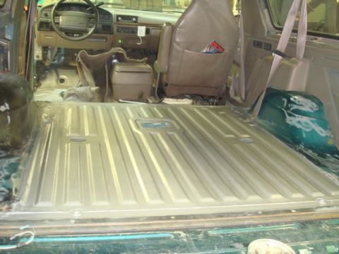 1996 Ford Bronco - The interior of a 1996 Ford Bronco shows the floor stripped and ready for rust treatment and repair.