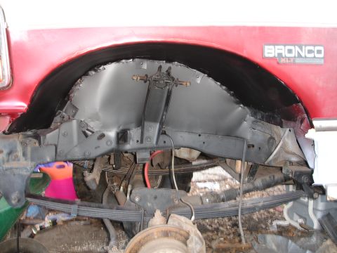 1989 Ford Bronco - Close-up of the rear wheel well and suspension on a 1989 Ford Bronco XLT.