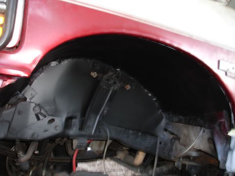 1989 Ford Bronco - This image shows the underside of a vehicle, focusing on the wheel well and chassis components.