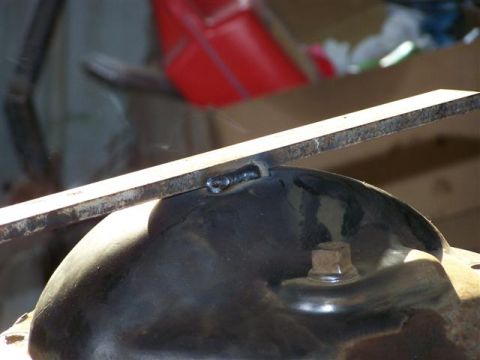 1995 Ford Bronco - Metal plate being welded to a vehicle's differential cover.