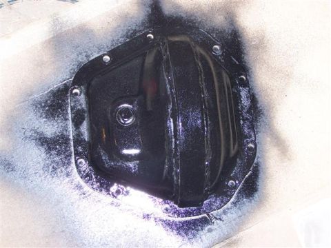 1995 Ford Bronco - Differential cover with bolts, showing signs of recent spray paint application.