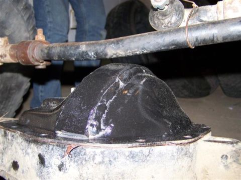1995 Ford Bronco - Close-up of a differential housing with a black cover and visible metal tie-wrap.