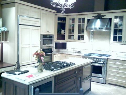 2006 Ford E350 - A well-equipped kitchen features cream cabinetry and a central island with a stovetop.