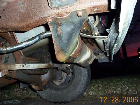 1989 Ford F-150 - Close-up view of the undercarriage, showing rust and suspension parts on a truck.