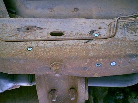 1983 Ford Bronco - here is the pass side mount. you can see the holes o marked. that is the fuel tank vent line. i moved it out of the way.