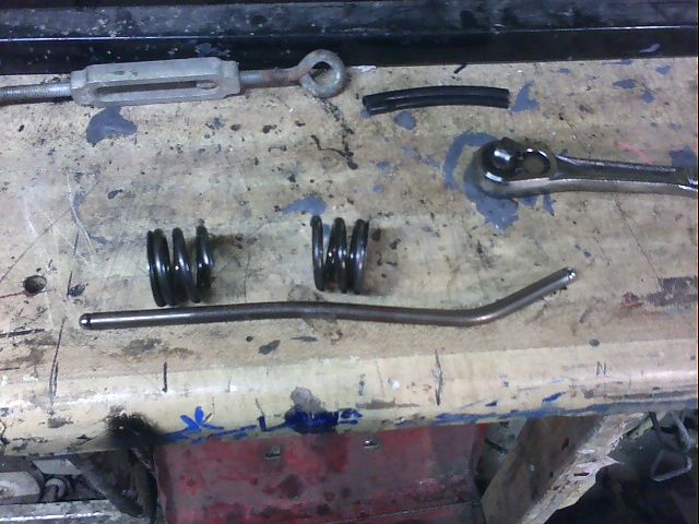 Valve springs, pushrod, and ratchet on workbench